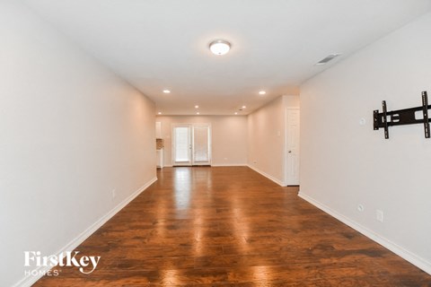 A room with wooden floors and white walls.