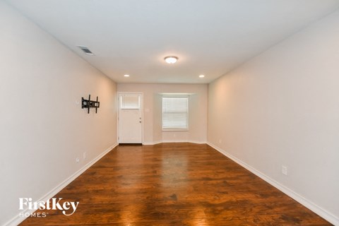 A room with wooden floors and white walls.