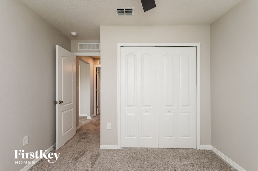 A white door is in a room with a carpet floor.
