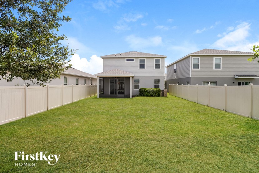 A well-maintained lawn in front of a modern house.