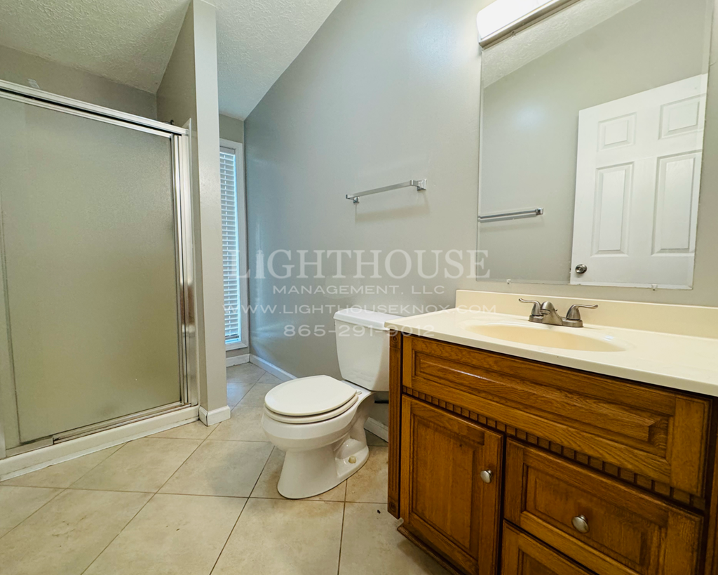 a bathroom with a toilet and a sink and a shower