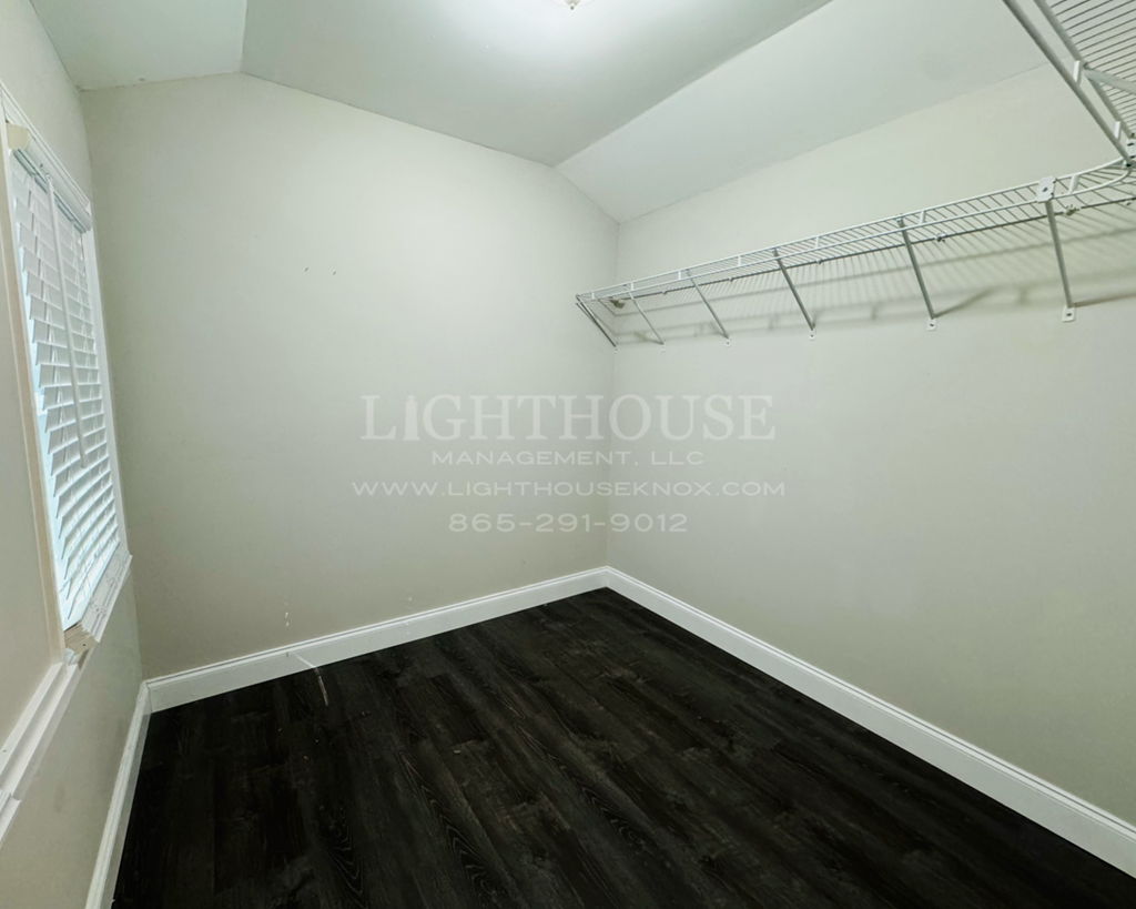 a bedroom with a closet and a hanger on the wall