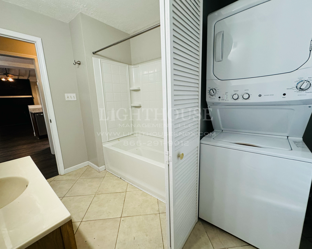 a laundry room with a washer and dryer and a sink