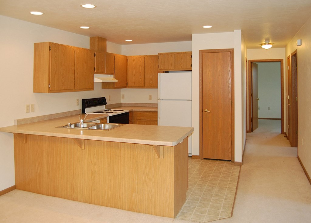 an empty kitchen with an island in the middle