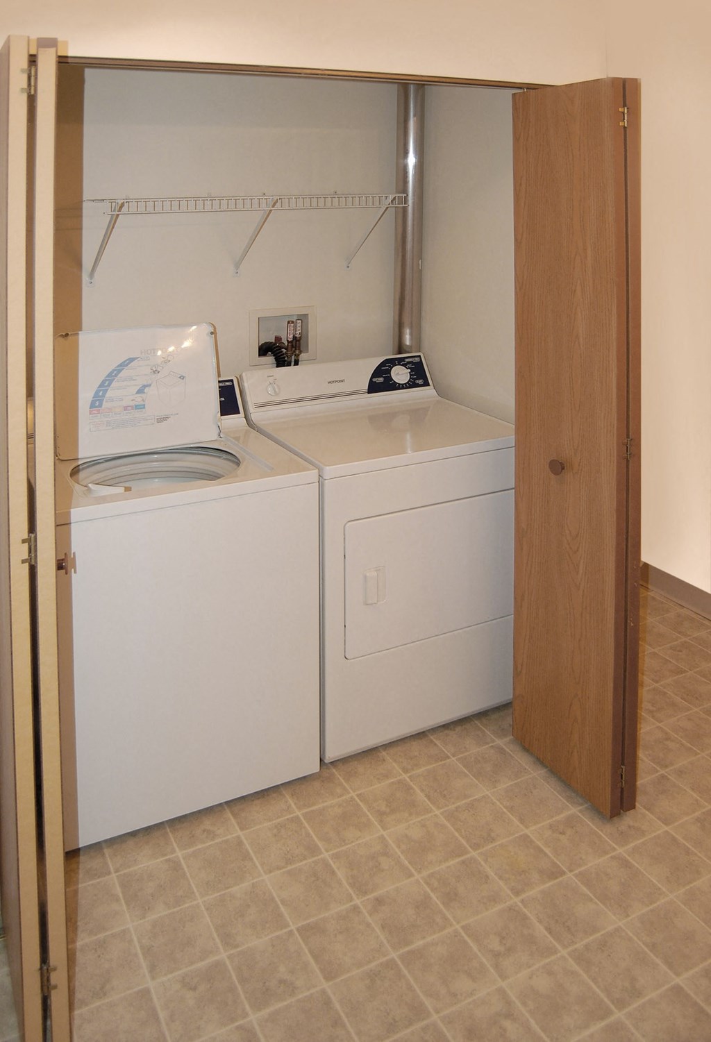 a laundry room with two washes and a dryer