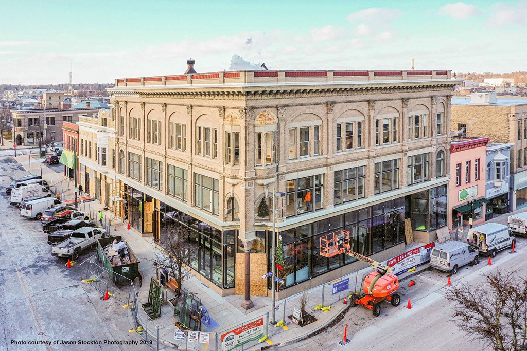 a crane is parked outside of a building on a city street