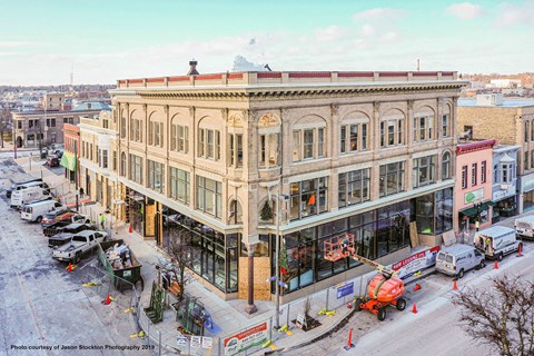 a crane is parked outside of a building on a city street