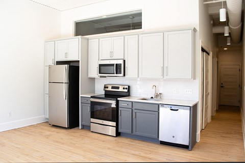 a kitchen with white cabinets and stainless steel appliances
