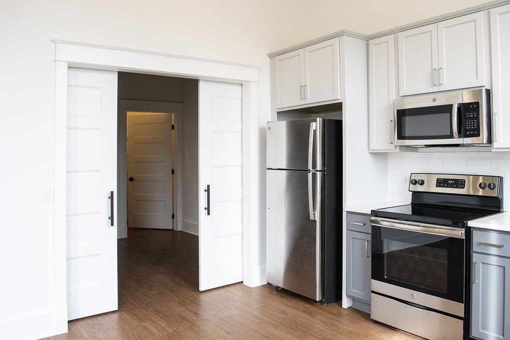 a kitchen with stainless steel appliances and white cabinets
