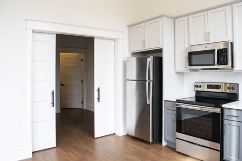a kitchen with stainless steel appliances and white cabinets