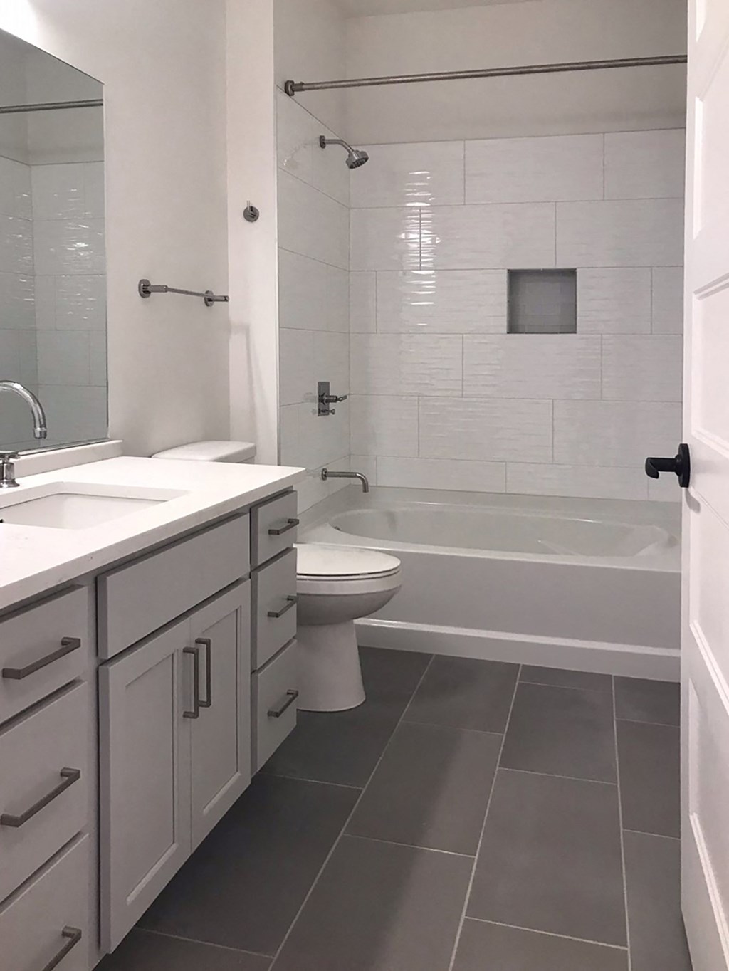 a bathroom with a toilet and a tub and a sink