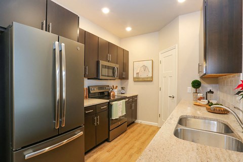 a kitchen with stainless steel appliances and granite counter tops