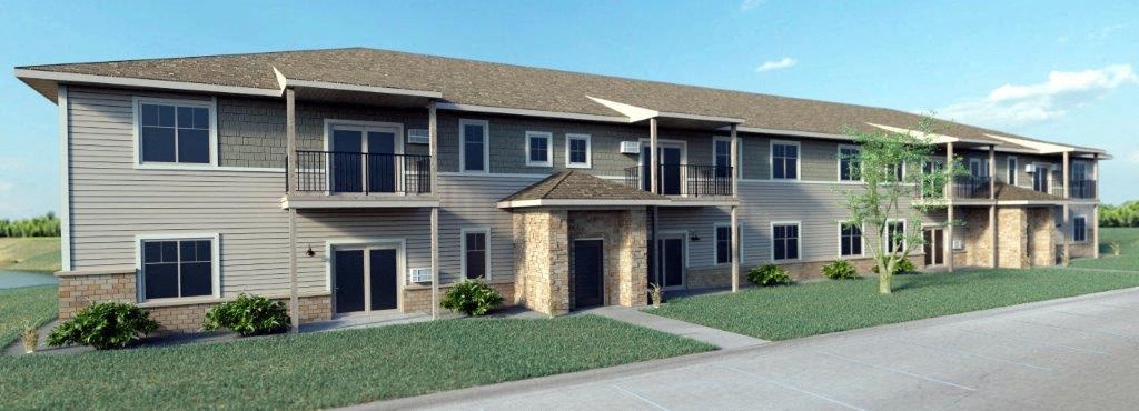 a large apartment building with a sidewalk and grass