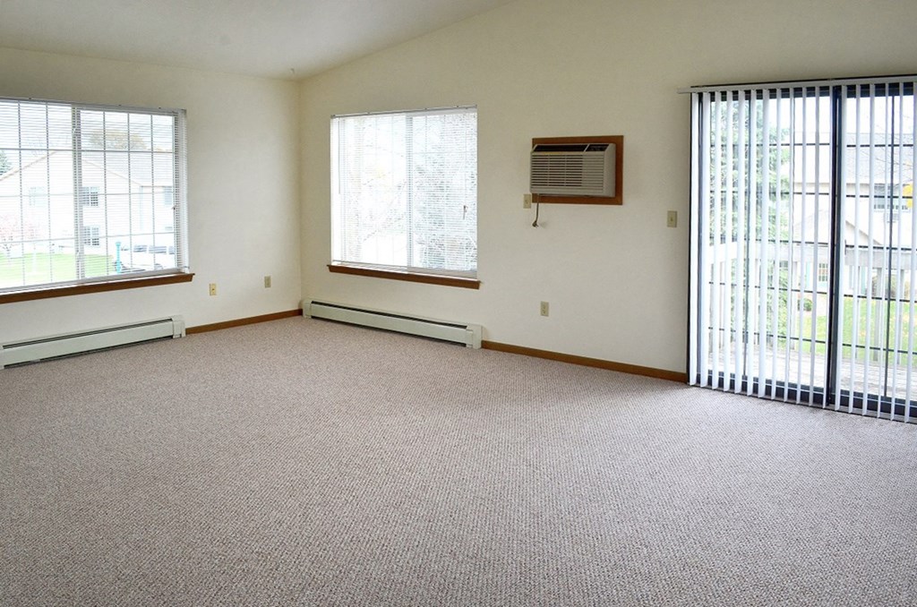the living room of an empty house with two windows
