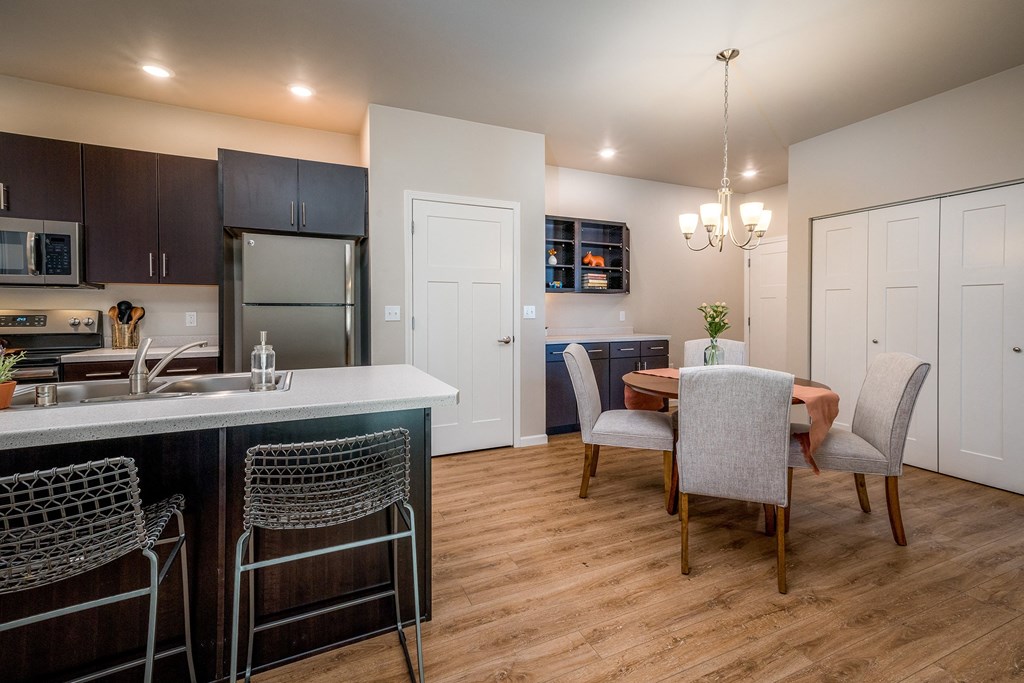 a kitchen and dining room with a table and chairs