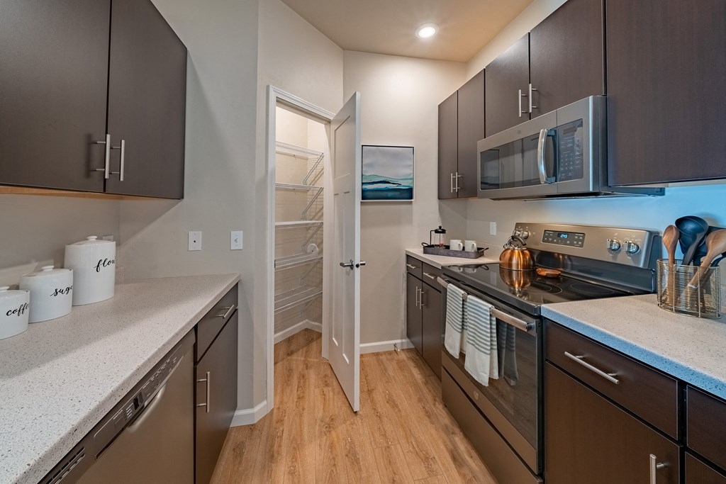 a kitchen with stainless steel appliances and a door to the laundry room
