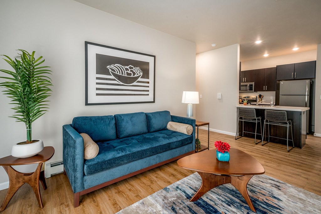 a living room with a blue couch and a coffee table