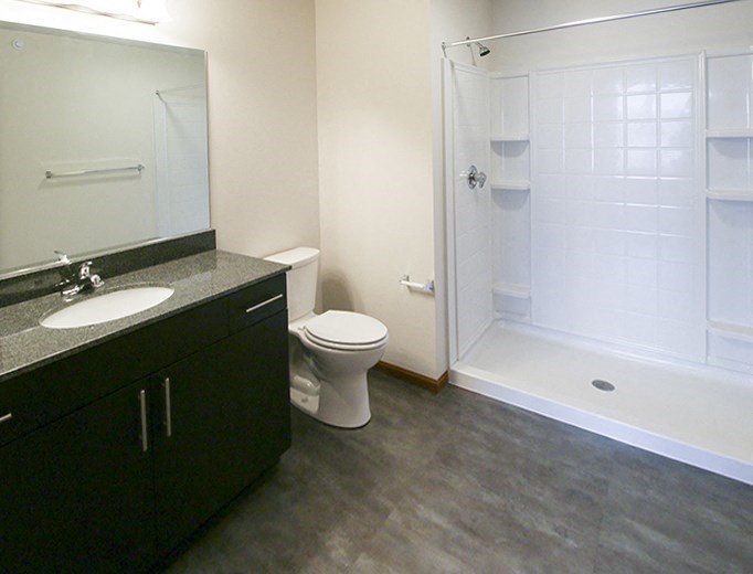 a bathroom with a toilet and a sink and a shower