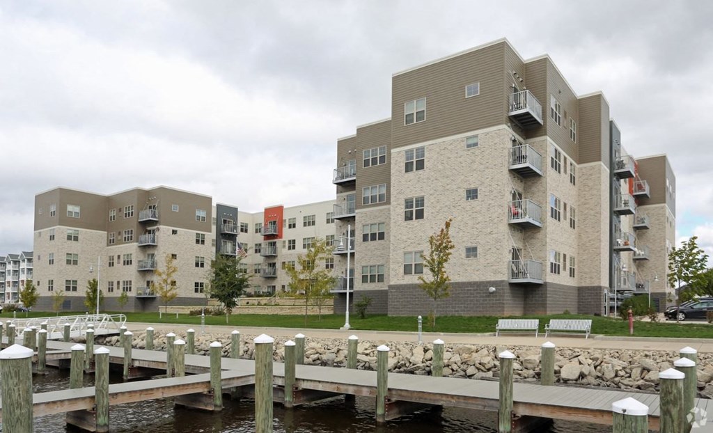 a view of an apartment building with a pier in the foreground