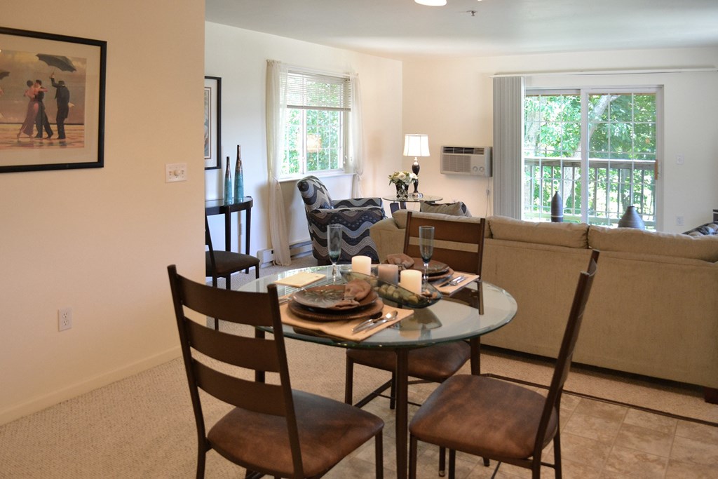 a living room with a dining room table and a couch