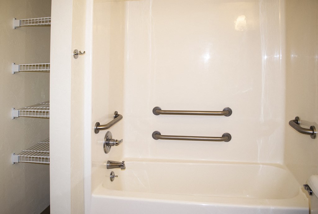 a bathroom with a shower and a sink and a bath tub