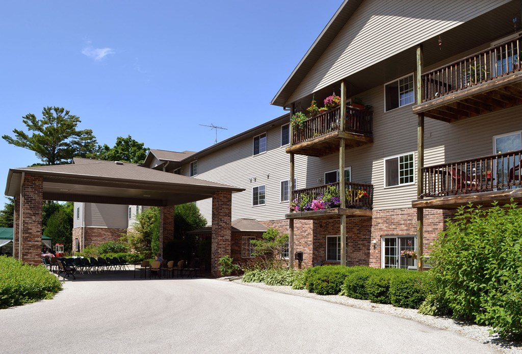 the view of a building with a driveway and a covered porch
