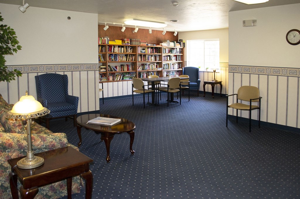 a lounge area of a library with chairs and tables