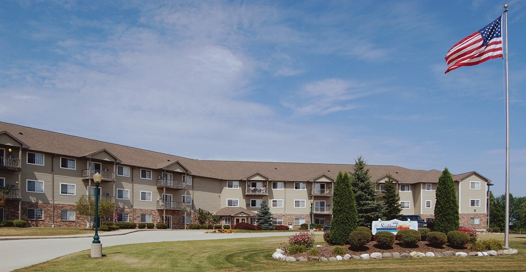 an flag flying in front of an apartment building