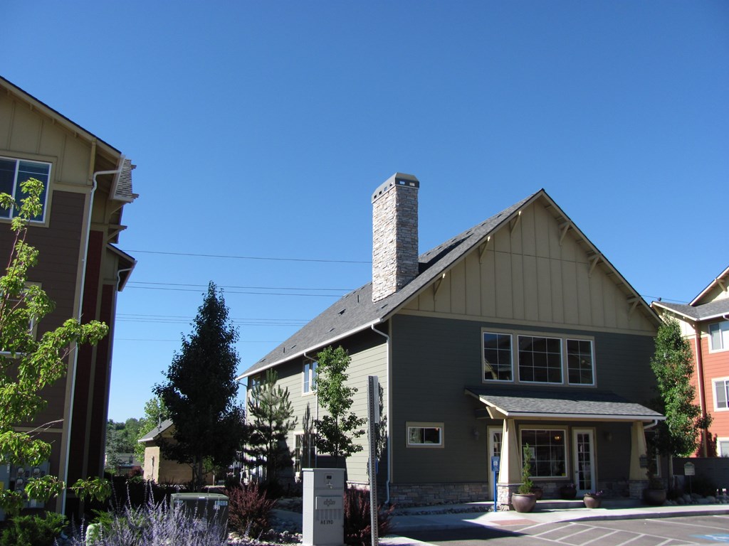 A house with a grey roof and a white chimney.