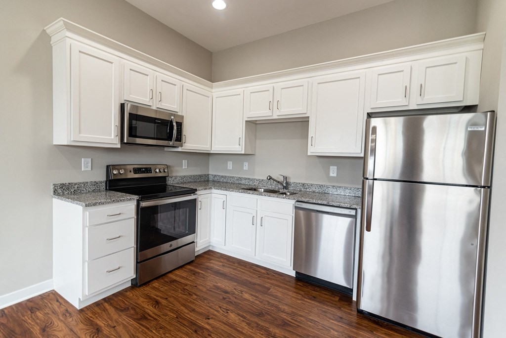 a kitchen with stainless steel appliances and white cabinets