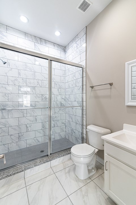 an image of a bathroom with a shower and a toilet