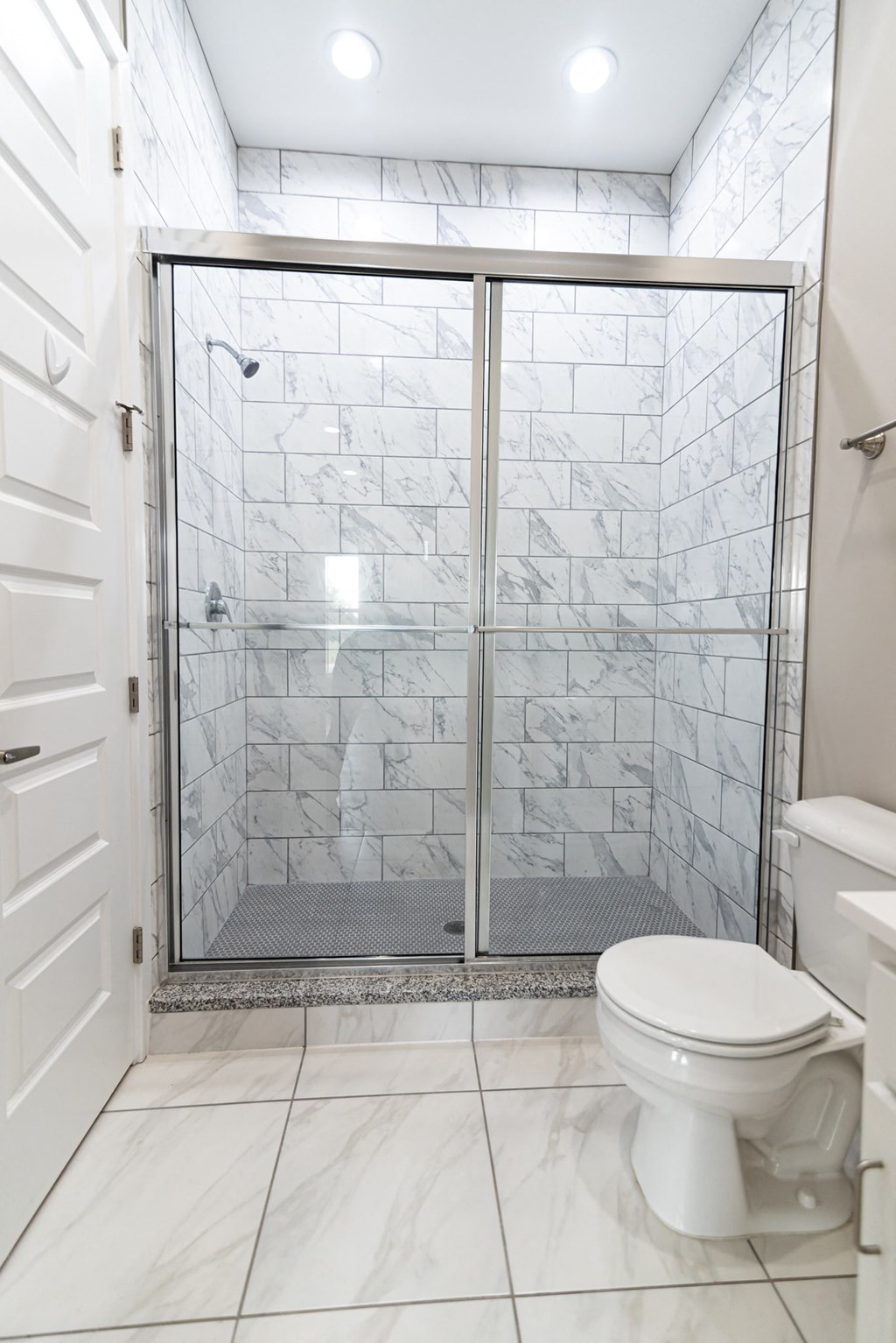 a small bathroom with a shower and a toilet