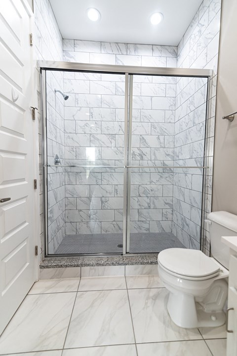 a small bathroom with a shower and a toilet