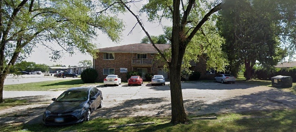 a house with cars parked in a parking lot