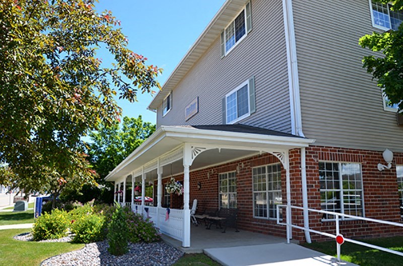 the front porch of a house with a porch swing
