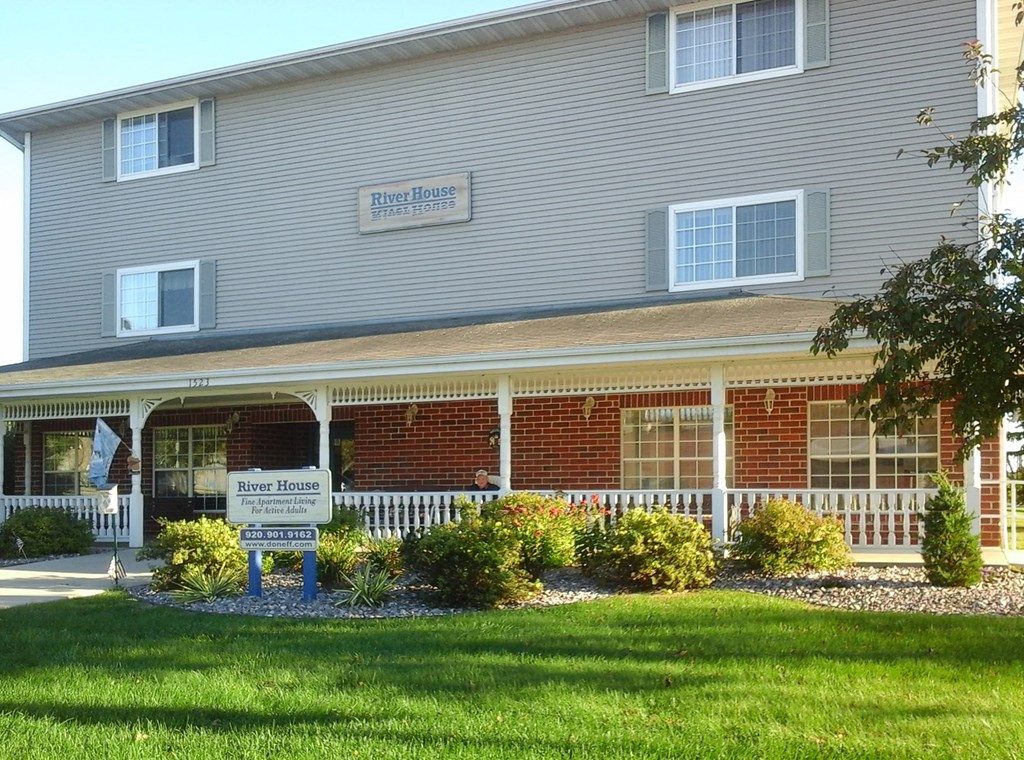 a building with a porch and a sign in front of it