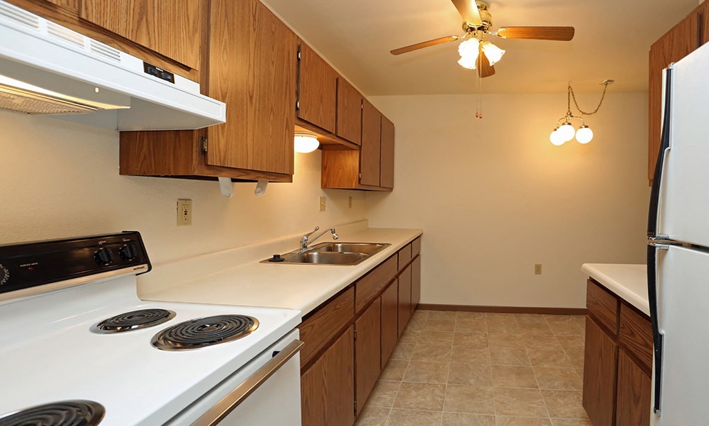 a kitchen with white appliances and wooden cabinets