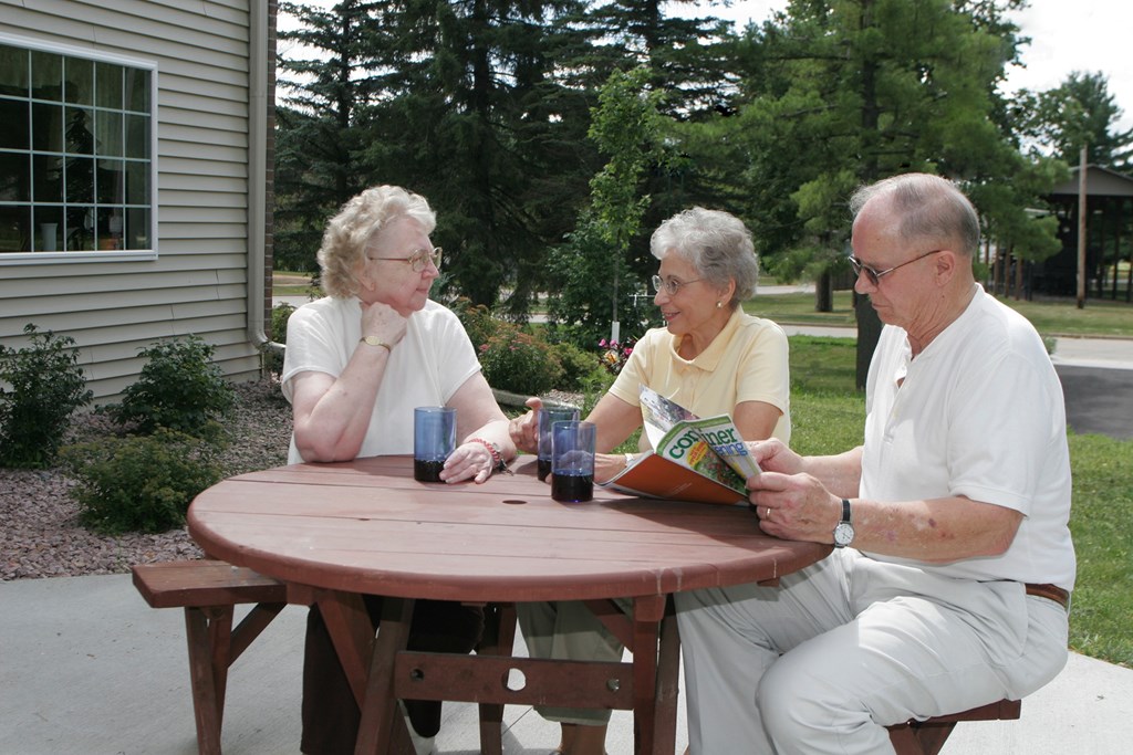 a group of people sitting at a picnic table