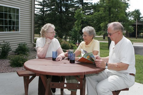 a group of people sitting at a picnic table