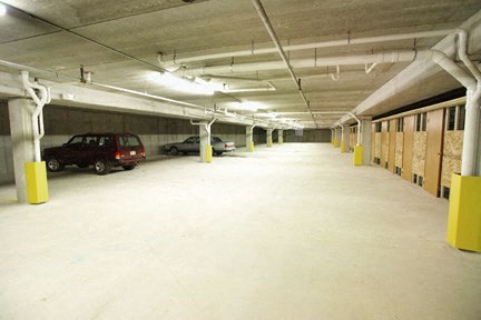an empty parking garage with cars parked in it