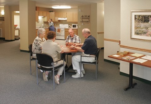 a group of people sitting around a table in a room