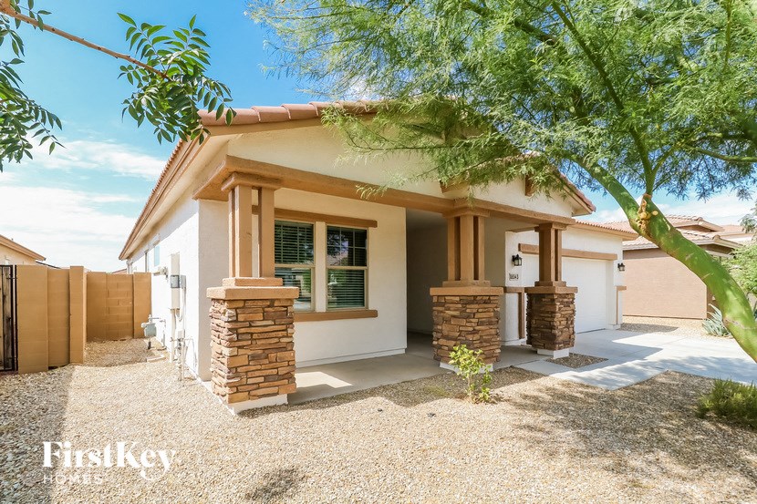 a small house with a tree in front of it