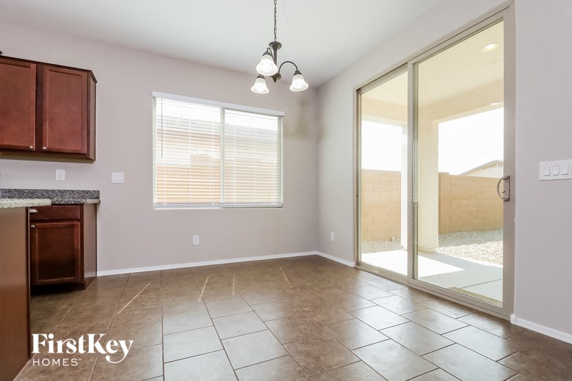 an empty kitchen and living room with a sliding glass door