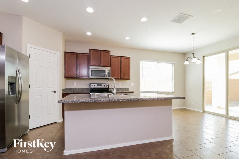 a kitchen with a counter top and a stainless steel refrigerator