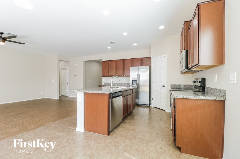 a large kitchen with wood cabinets and stainless steel appliances