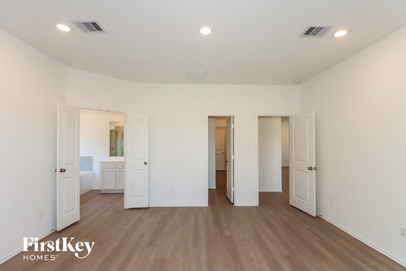 a renovated living room with white walls and wood flooring