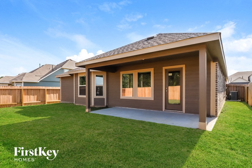 a home with a covered porch and a lawn