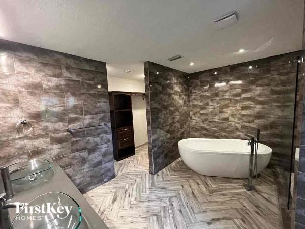 a bathroom with a bath tub in the middle of it