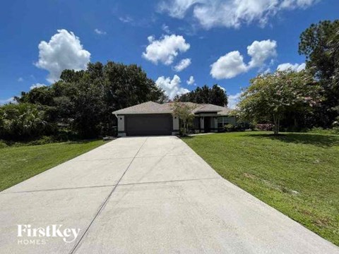 a house sitting on the side of a driveway