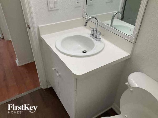 a bathroom with a white sink and a toilet